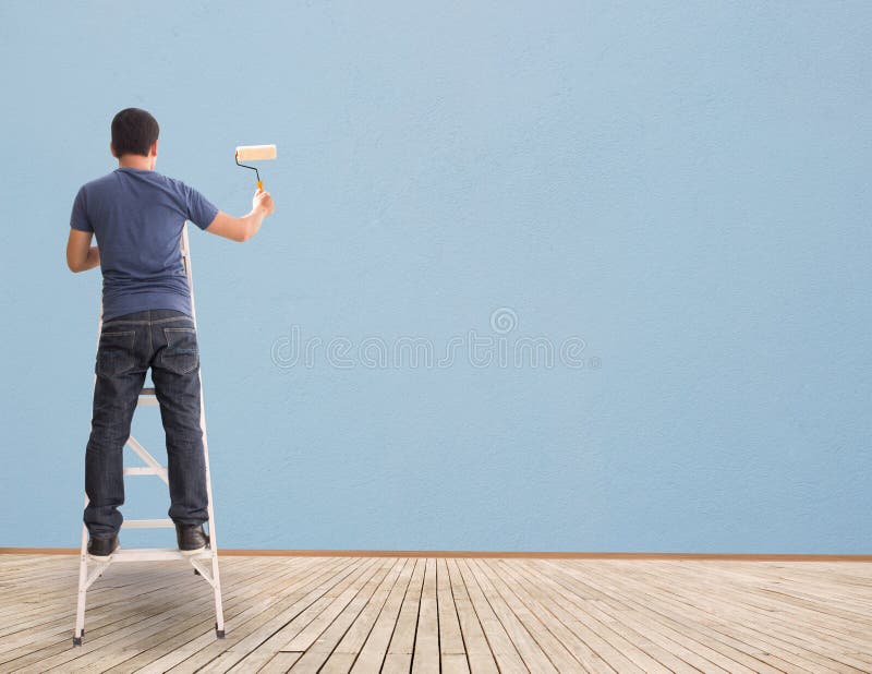 Man Painting On Blue Blank Wall