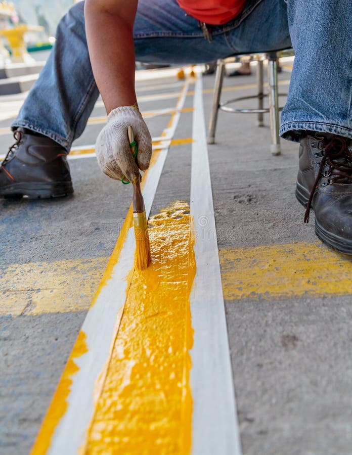 The Man is Painting the Concrete Road Stock Photo Image of motor, profession 37268550