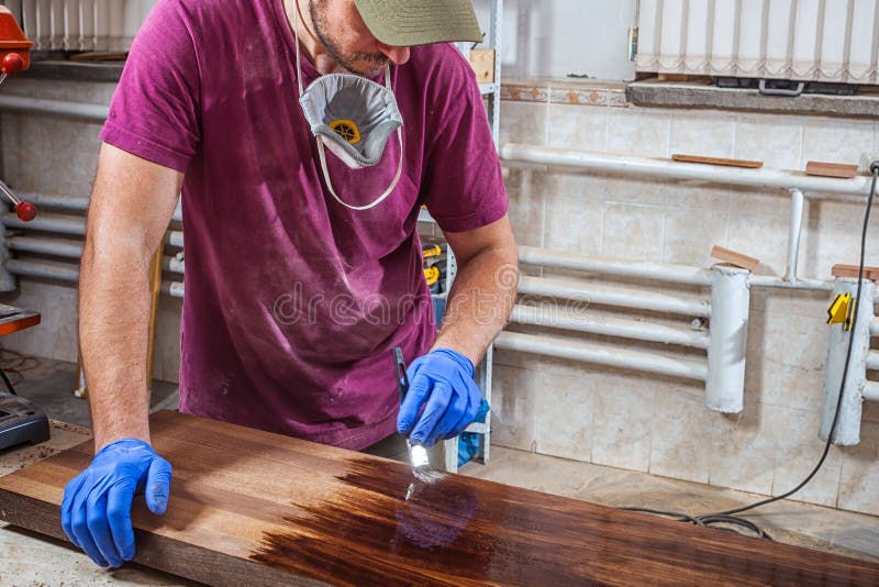 Man paints a wooden stock images Man paints a wooden stock images