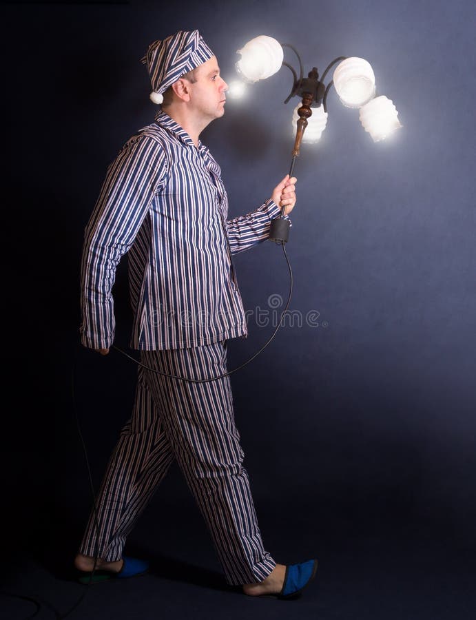 Man in Pajamas Carries Chandelier Stock Photo - Image of male, alone ...
