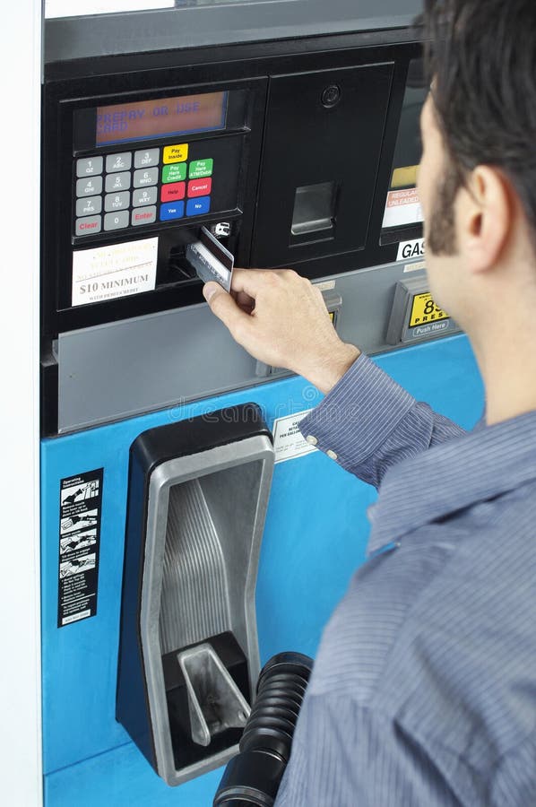 Man Paying With Credit Card At Fuel Pump