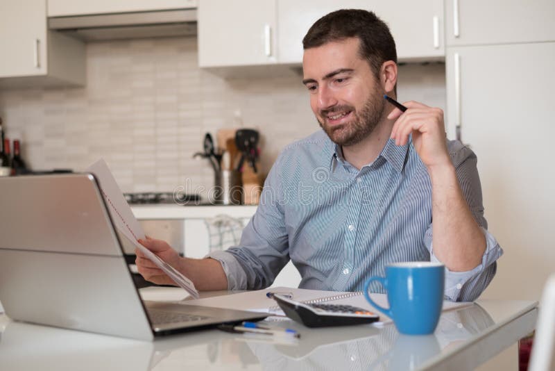 Man paying invoices using internet online services stock photos Man paying invoices using internet online services stock photos