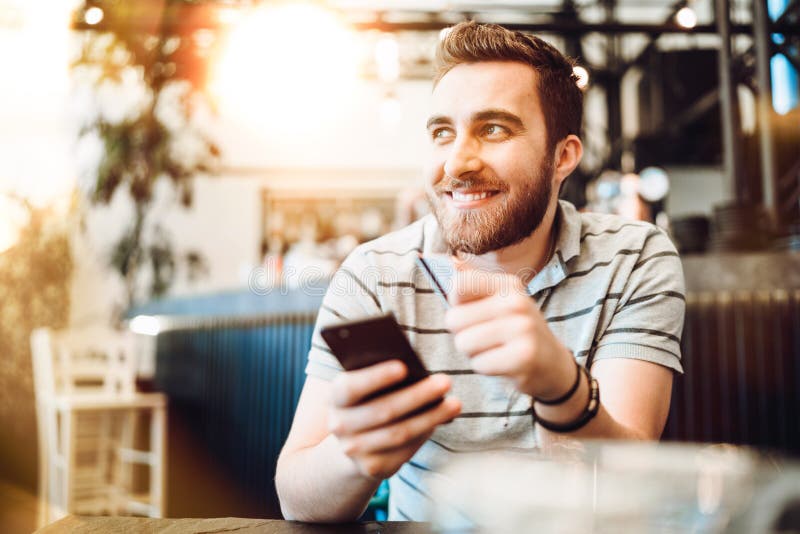 Man paying using credit card and mobile phone. Modern payment systems concept royalty free stock photo
