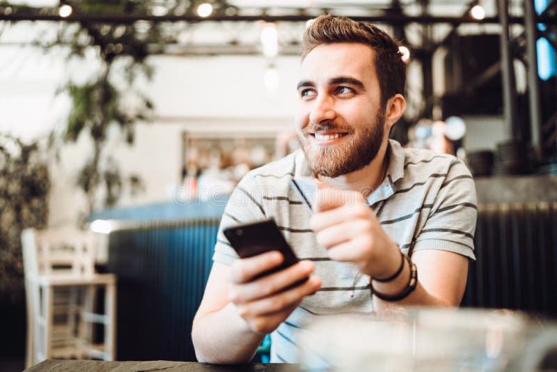 Man paying using credit card and mobile phone. Modern payment systems concept royalty free stock image