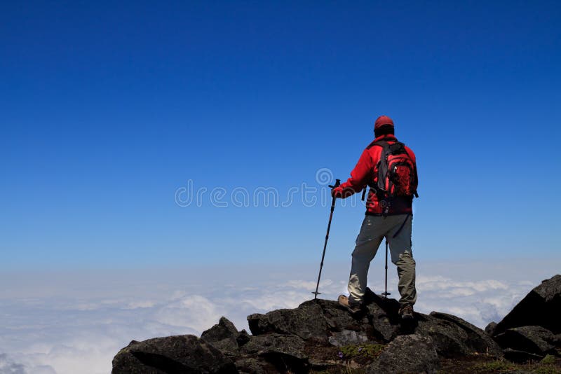 Man on peak of mountain. royalty free stock photos
