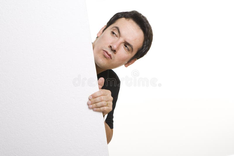 Man peeking behind empty billboard