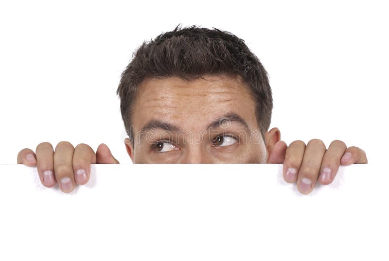 Man peeking behind empty white billboard