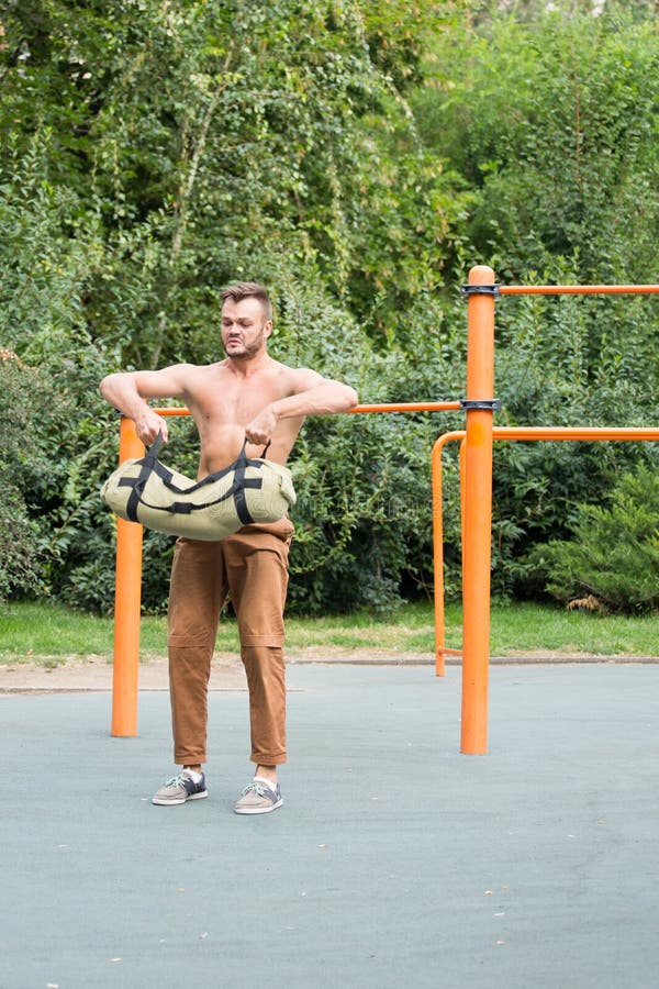 Man Performing Bag Squat Exercise Outdoor Stock Image Image of summer