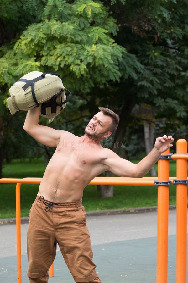 Man Performing Bag Squat Exercise Outdoor Stock Photo Image of
