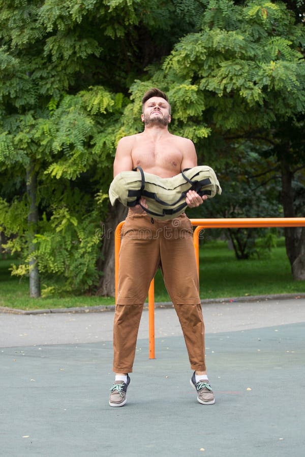 Man Performing Bag Squat Exercise Outdoor Stock Image Image of