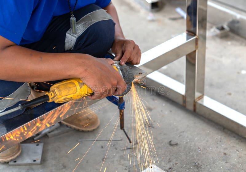 The Man Use Electric Grinding Stainless Steel in Stock Photo