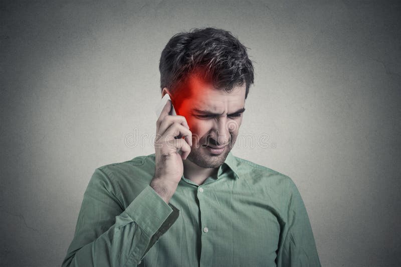 Man on the phone with headache. Cellular mobile radiation concept stock photography Man on the phone with headache. Cellular mobile radiation concept stock photography
