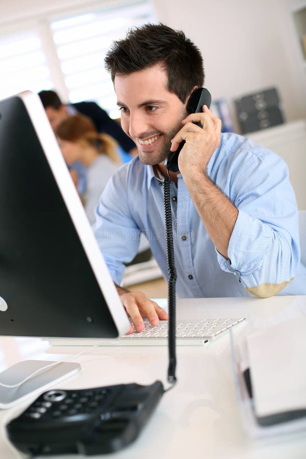 Man on the phone in office stock photo. Image of office 31545838
