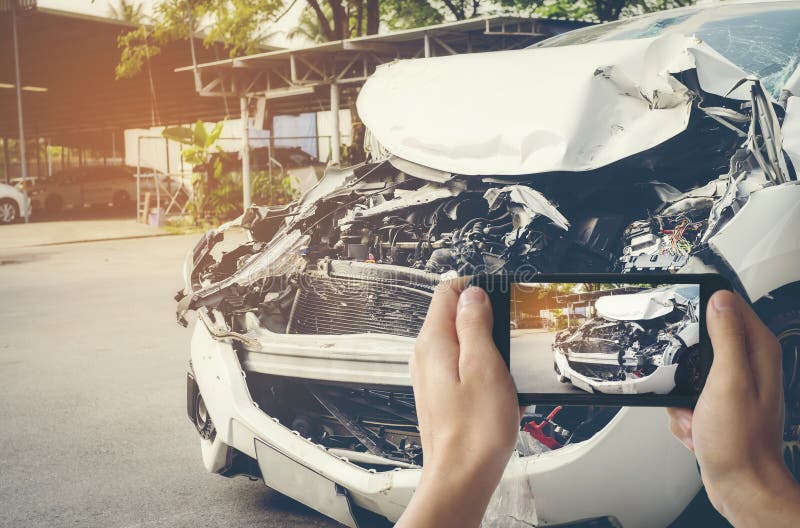 A man photographed his vehicle with accidental damage with a smart phone.Car Insurance Concept stock photography A man photographed his vehicle with accidental damage with a smart phone.Car Insurance Concept stock photography