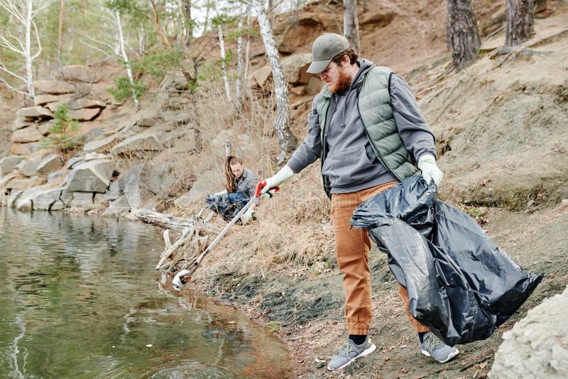 Man Picking up Trash stock photo. Image of care, trash 268523258