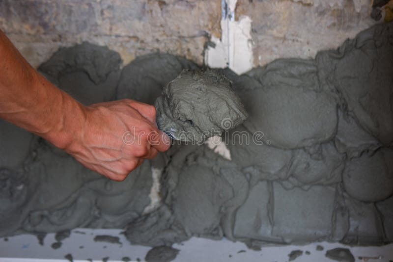 Man Plastering the Wall. Construction, Repairs in the House Stock Image