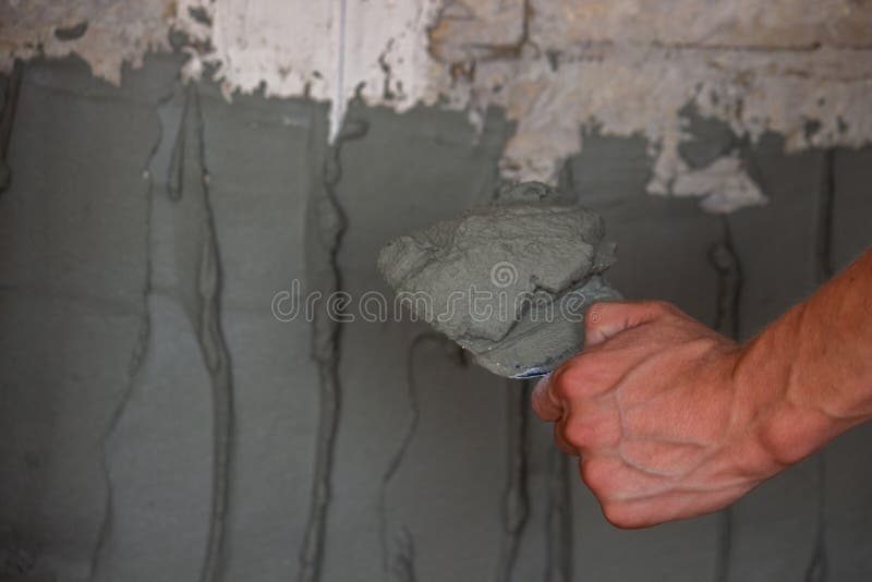 Man Plastering the Wall. Construction, Repairs in the House Stock Photo