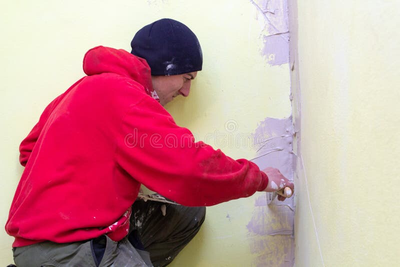 Man Plastering the Wall,young Master Putty Cracks in the Wall in the