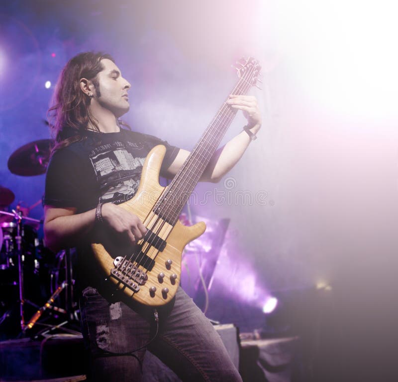 Man playing bass guitar in live concert sequence. Live music background royalty free stock photo Man playing bass guitar in live concert sequence. Live music background royalty free stock photo