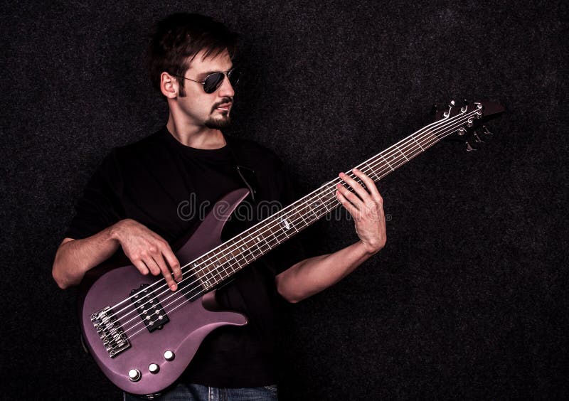 Bass playing. Playing Bass Guitar. Man playing Bass Guitar. Bass player