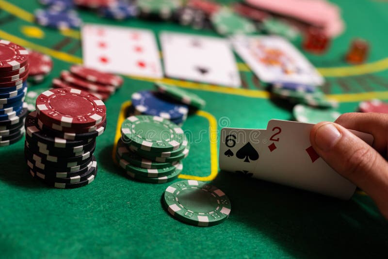 Man Playing Blackjack at the Table and Betting Chips Stock Photo
