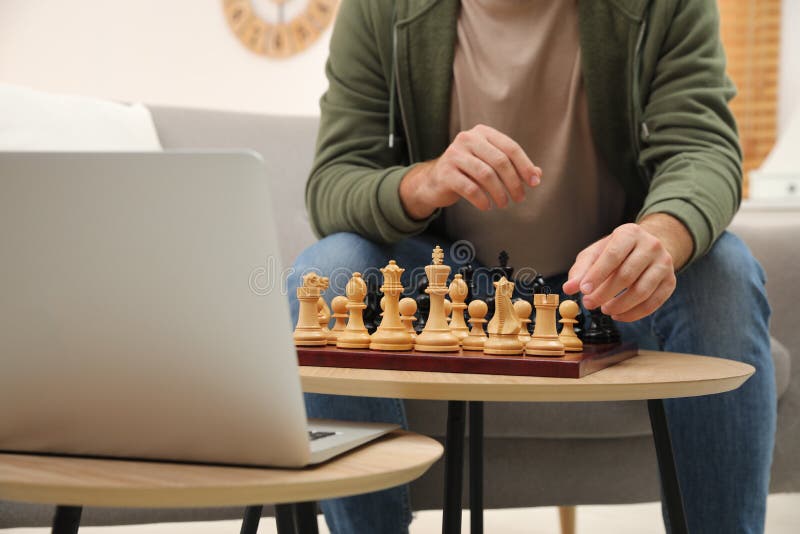 Man playing chess online on tablet computer Stock Photo