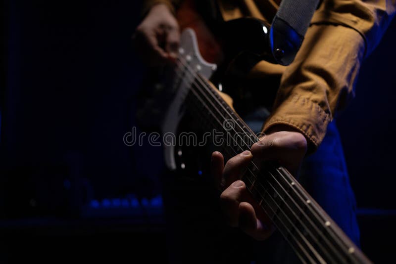 Man Playing Electric Guitar. Musician in Studio Holding Electric Guitar