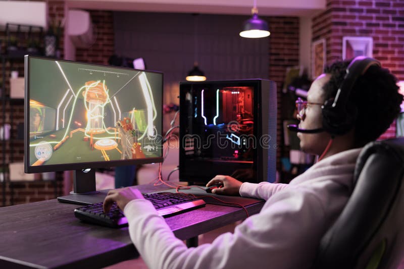 Handheld shot of african american man using pc gaming setup