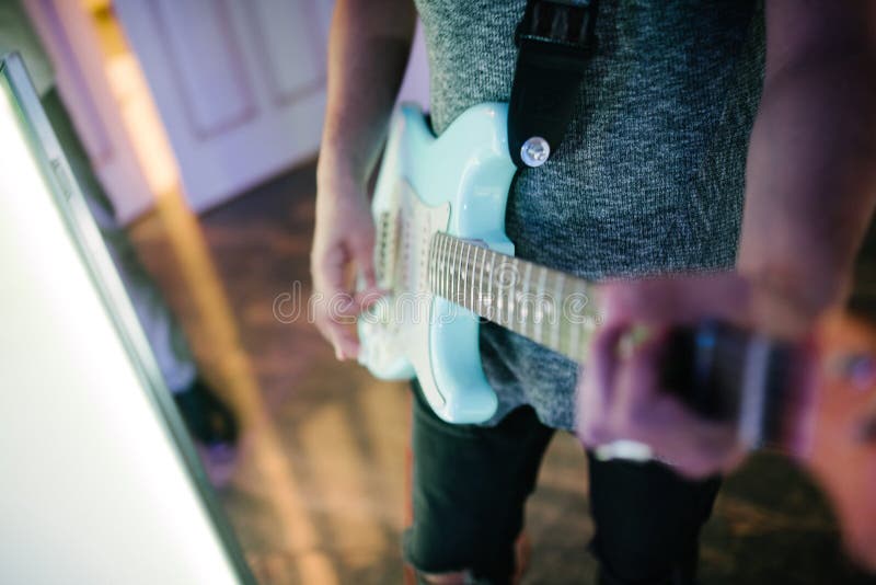 Man playing guitar indoors closeup on the photo stock photos Man playing guitar indoors closeup on the photo stock photos