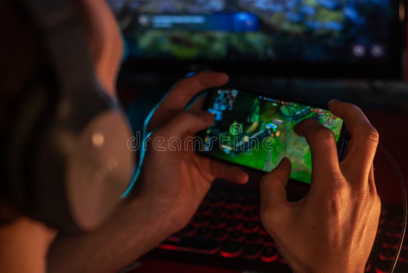 Young Boy and Girl Play Games and Listen To Music on Mobile Phones Stock  Photo - Image of hand, gamer: 135473906