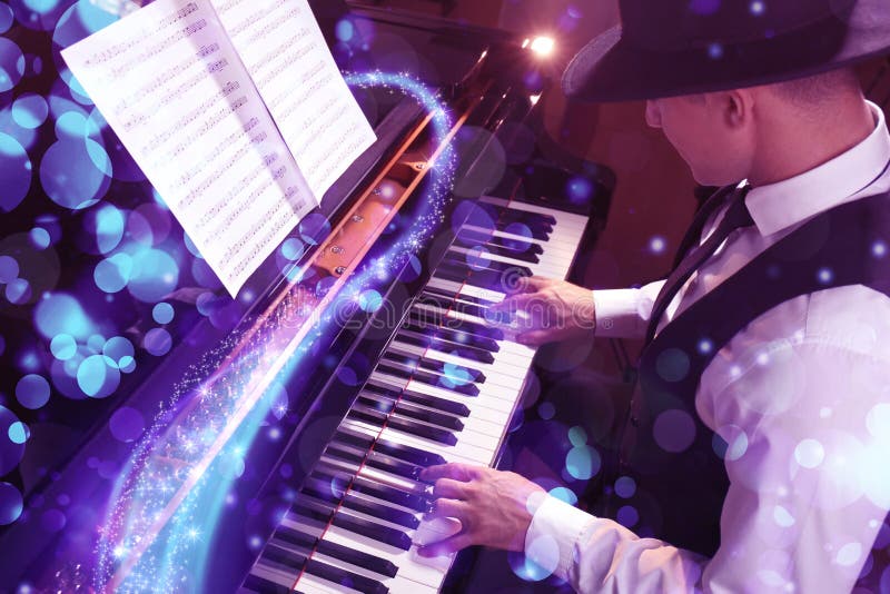Man playing piano indoors, above view. Bokeh effect stock photos