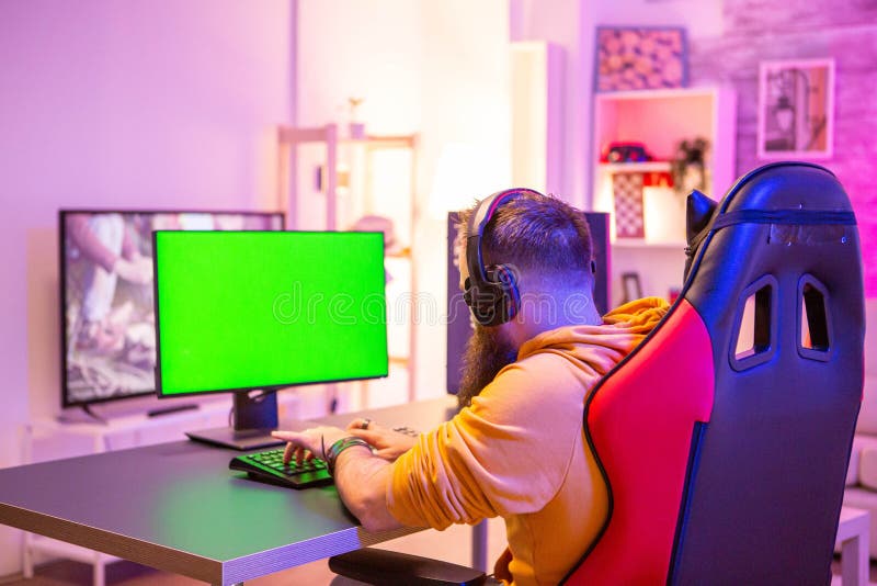 Man Playing on Powerfull Gaming Pc in a Room with Neon Lights on a ...