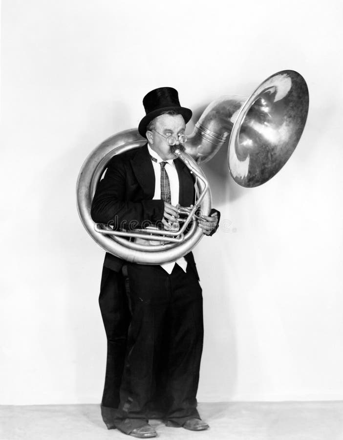 Man playing a tuba in a top hat