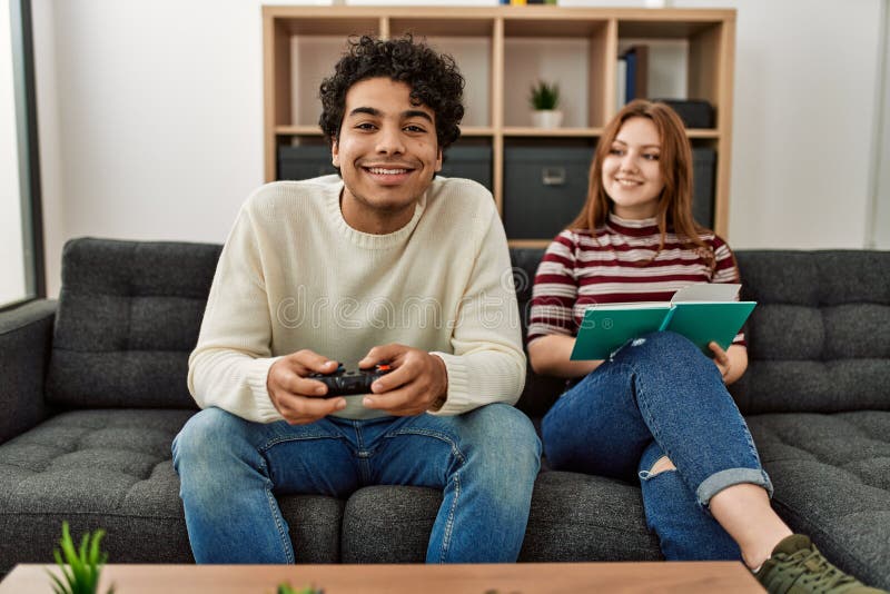 Young Cute Competitive Boyfriend Girlfriend Playing Video Games In Couch  Stock Photo, Picture and Royalty Free Image. Image 34313215.