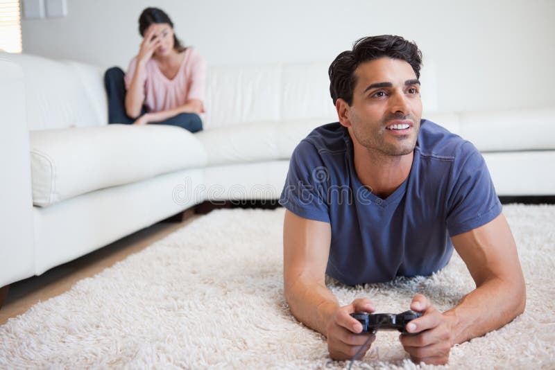 Premium Photo  Boyfriend sits engrossed in playing online games on his  smartphone, ignoring his girlfriend waiting.