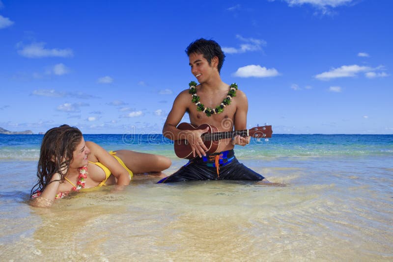 Man plays his ukulele for a young woman