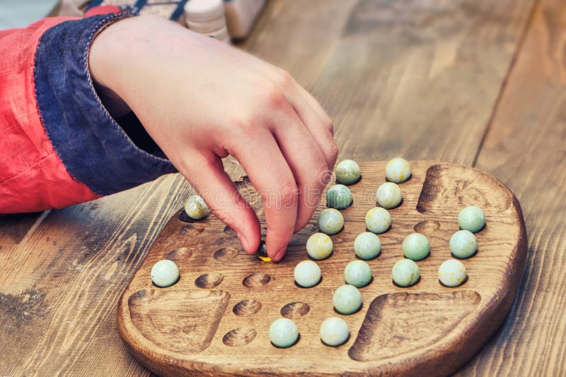 A Man Plays a Retro Board Game Mill. an Old Intellectual Game for Two