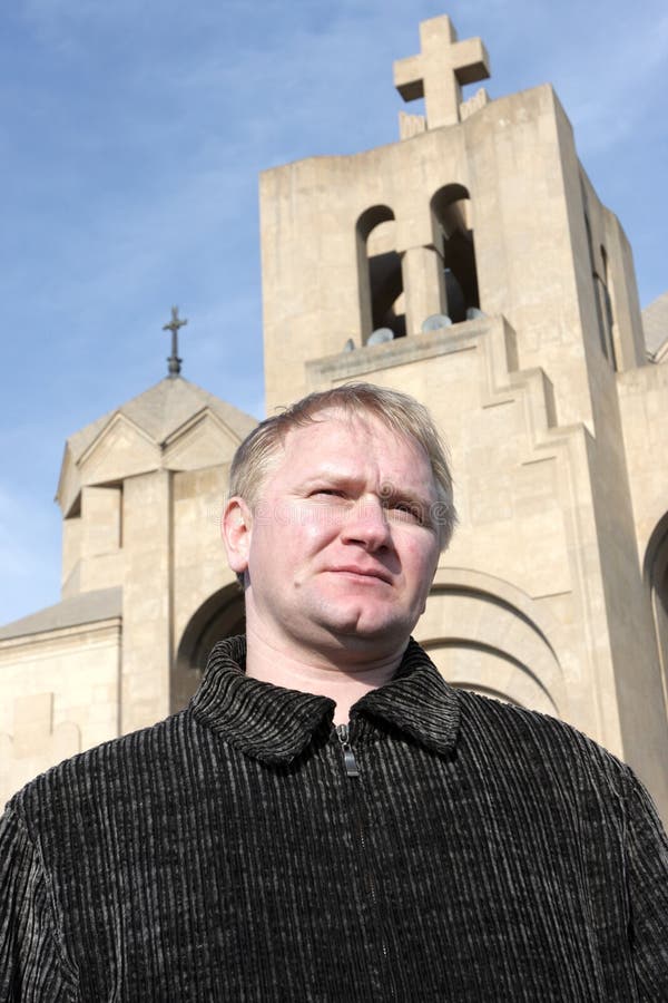 Man poses on church background