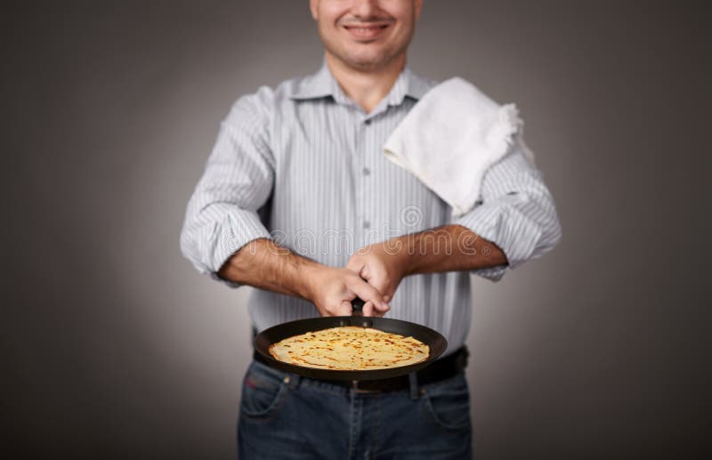 Man Posing with a Pancake in a Pan, White Shirt and Pants, Gray