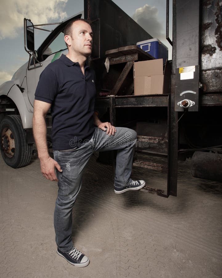 Man posing by a truck