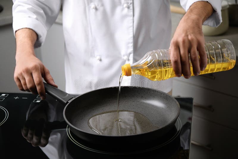 Man Pouring Cooking Oil From Bottle Into Frying Pan Stock Image Image