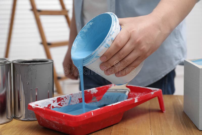 Pouring Paint Into A Painting Tray Stock Photo - Download Image