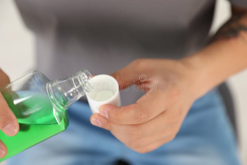 Man Pouring Mouthwash from Bottle into Cap Stock Image Image of background, hygiene 131945589