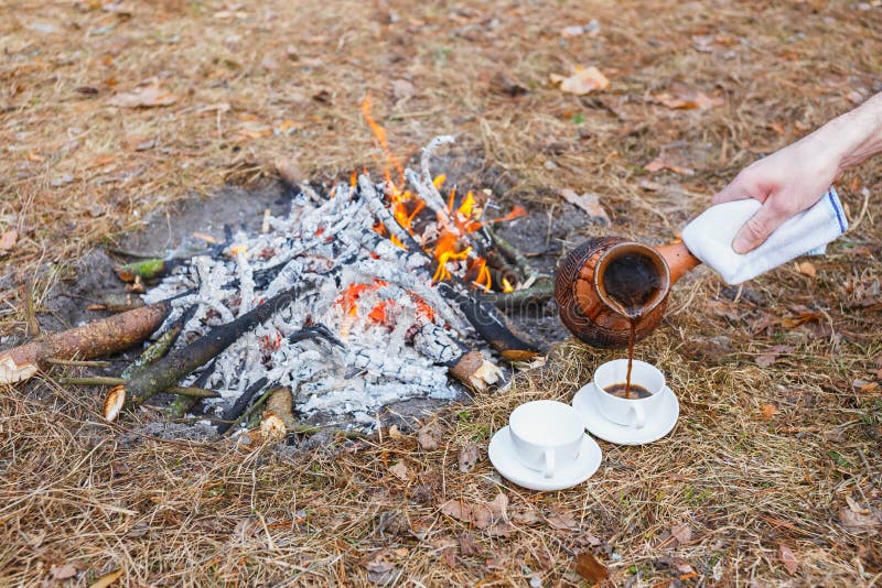 https://thumbs.dreamstime.com/b/man-pours-coffee-earthen-turkish-pot-small-white-cups-campfire-spring-forest-frame-hand-towel-143057120.jpg