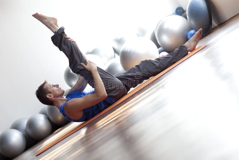 Man practicing pilates royalty free stock photography
