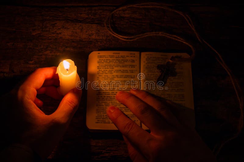 Man Praying on the Bible in the Light Candles Stock Photo Image of