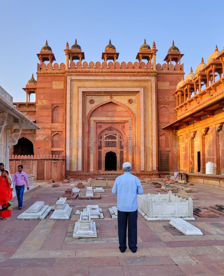 Man praying at Jama Masjid at Fatehpur Sikri, former capital of the Mughal Empire founded in 1571 by Emperor Akbar, a UNESCO World Heritage Site. Agra, Uttar Pradesh, India. Man praying at Jama Masjid at Fatehpur Sikri, former capital of the Mughal Empire founded in 1571 by Emperor Akbar, a UNESCO World Heritage Site. Agra, Uttar Pradesh, India