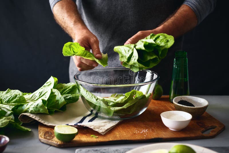 Man preparing green salad romaine lettuce healthy food