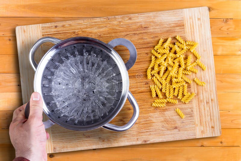 Man Preparing To Cook Dried Italian Rotini Pasta Stock Photo - Image of