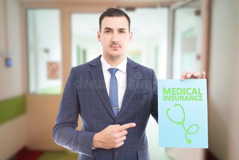 Man presenting paper sign with medical insurance stock photo Man presenting paper sign with medical insurance stock photo